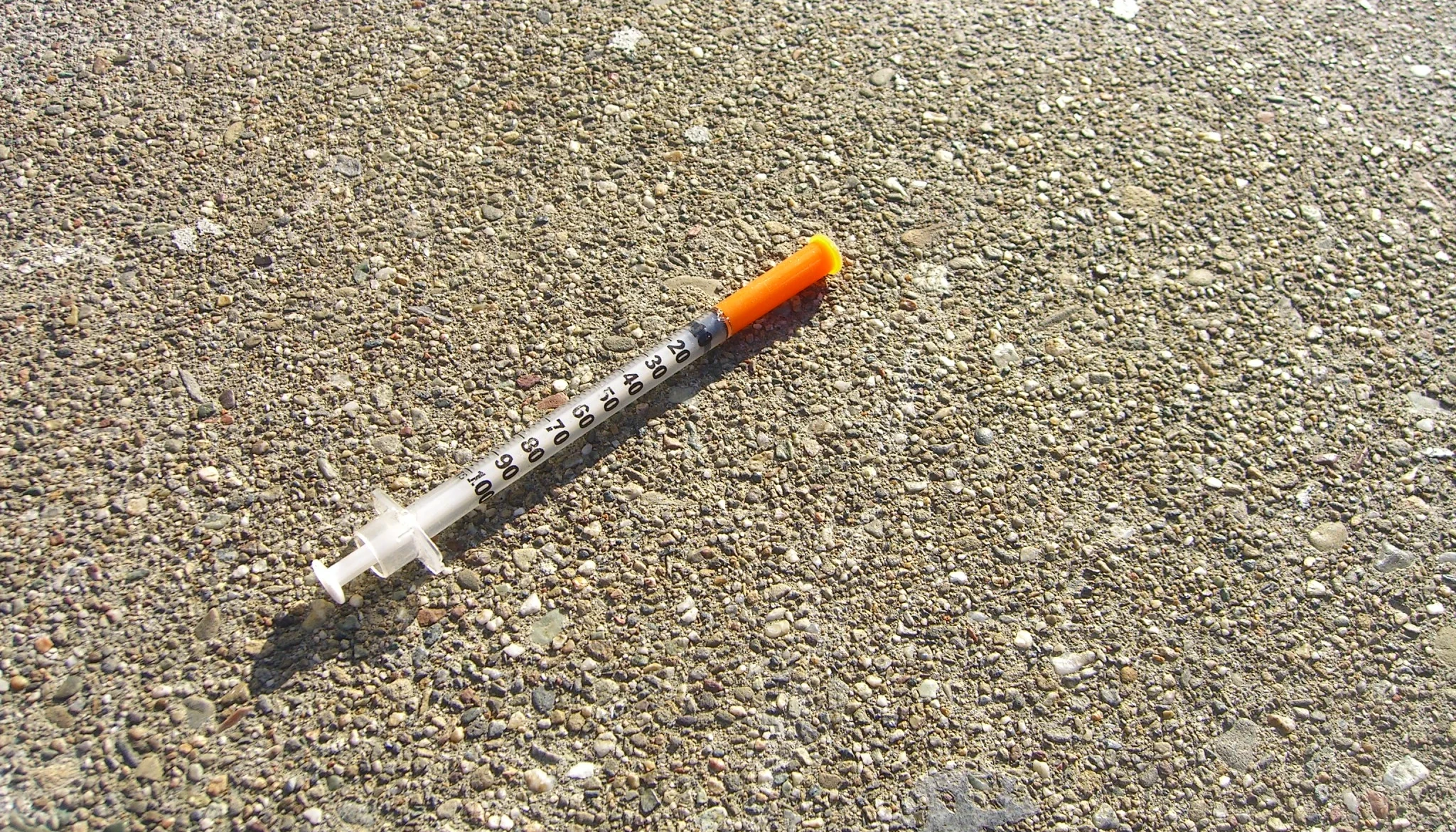 Unused Needle on the Sidewalk